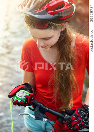 Bicycle compass in hands. Cyclist looking for way. 39229784