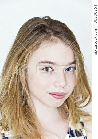 Teenager girl with blond long hair and big eyes on white wall 39230253