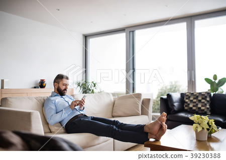 A man holding a smartphone. Smart home. A man holding a smartphone. Smart home. 39230388