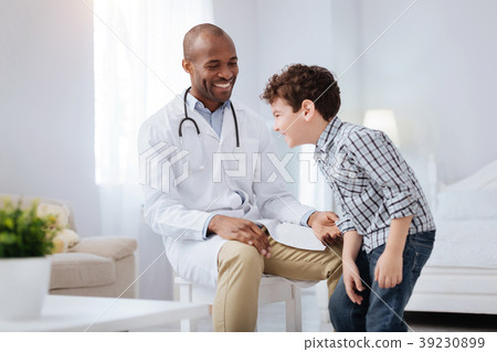 Charming male doctor and boy having fun Charming male doctor and boy having fun 39230899