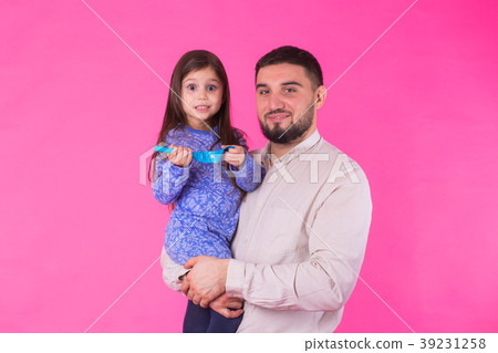 Happy father holding baby daughter in hands over Happy father holding baby daughter in hands over 39231258