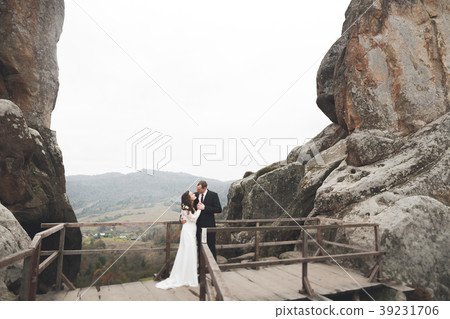 Wedding couple in love kissing and hugging near Wedding couple in love kissing and hugging near 39231706