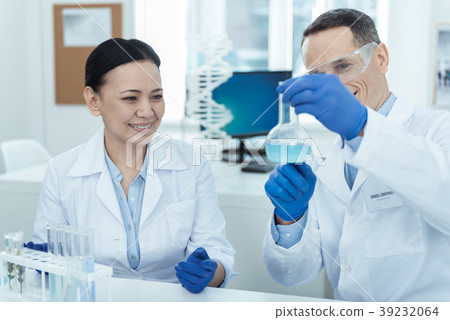 Alert researchers making an experiment in the lab Alert researchers making an experiment in the lab 39232064