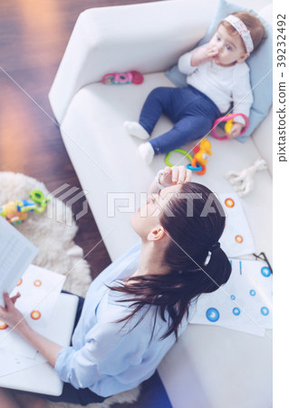Unhappy stressed woman being surrounded by papers 39232492