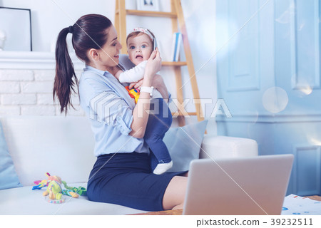 Joyful positive woman looking at her daughter 39232511
