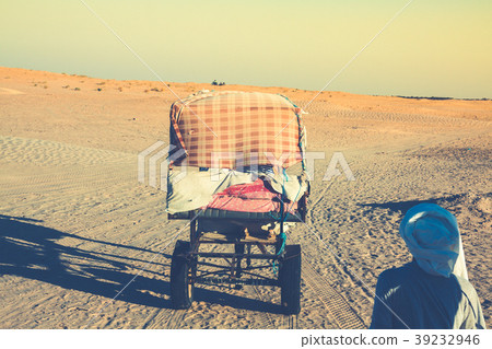 Beduins leading tourists on camels at short Beduins leading tourists on camels at short 39232946