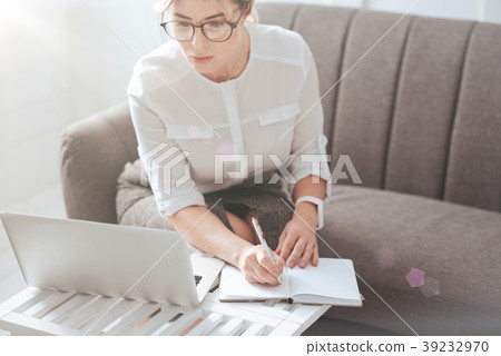 Beautiful modern businesswoman taking notes Beautiful modern businesswoman taking notes 39232970