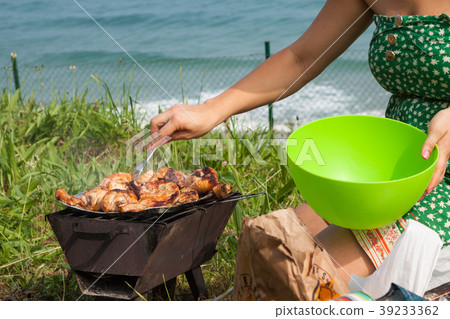 Grilled chicken thighs on the flaming grill. 39233362