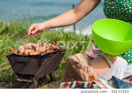 Grilled chicken thighs on the flaming grill. 39233363