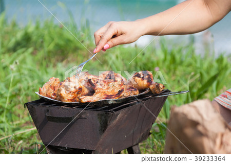 Grilled chicken thighs on the flaming grill. Grilled chicken thighs on the flaming grill. 39233364
