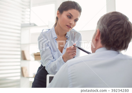 Attractive nice woman looking at her colleague 39234280