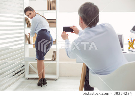 Cheerless young woman looking at the smartphone 39234284