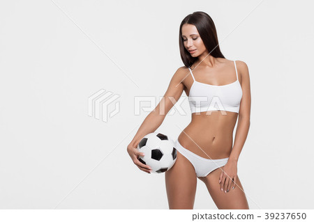 Sexy brunette with a soccer ball 39237650