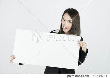 Asian businesswoman holding blank white card board Asian businesswoman holding blank white card board 39239261