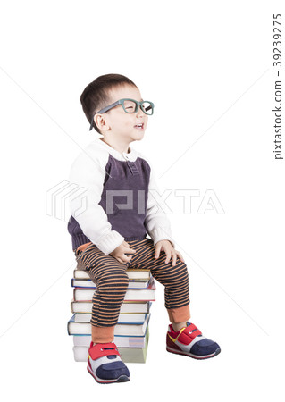 Preschooler boy sitting on the books 39239275
