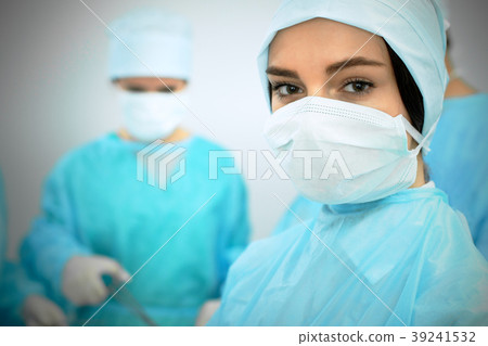 Medical team in masks performing operation. Focus 39241532