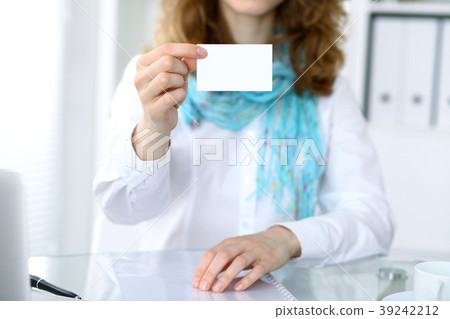 Close-up of business woman giving a visit card Close-up of business woman giving a visit card 39242212