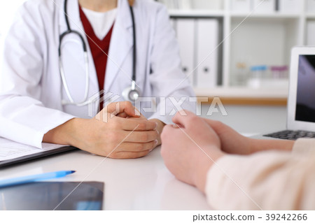 Close up of a doctor and patient hands while 39242266