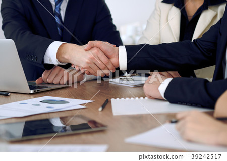 Close up of business people shaking hands at Close up of business people shaking hands at 39242517