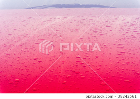 Dew drops on the red car after morning. Dew drops on the red car after morning. 39242561
