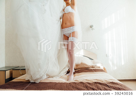 very sexy bride puts on a white dress 39243016