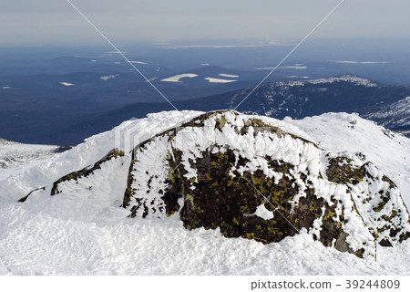 view from a mountain pass with a snow-covered boul 39244809