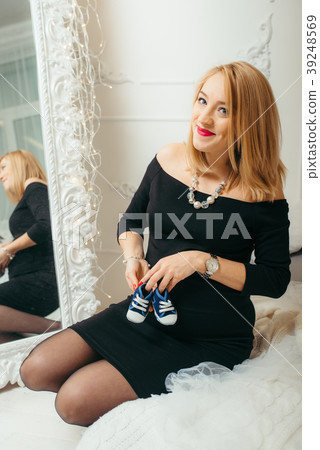 Charming pregnant woman with lovely smile is Charming pregnant woman with lovely smile is 39248569