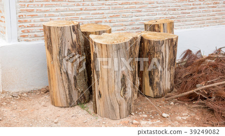 A pile of firewood near a house. 39249082
