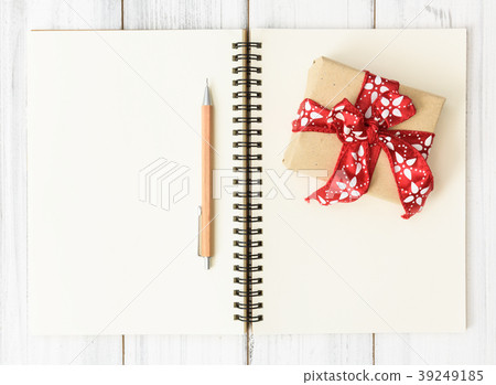 Notebook,brown pencil and red gift box on wood Notebook,brown pencil and red gift box on wood 39249185