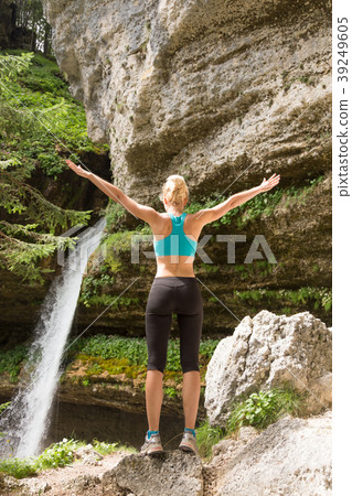 Active woman raising arms inhaling fresh air 39249605