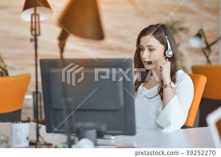 Attractive woman listening to music while working Attractive woman listening to music while working 39252270