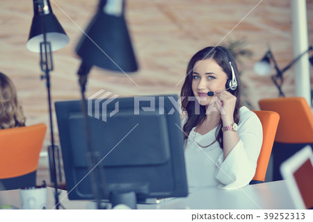 Attractive woman listening to music while working 39252313