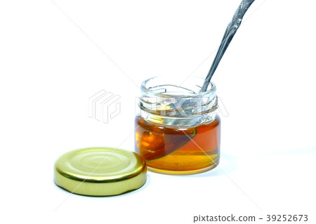 Honey in a glass bottle White background Honey in a glass bottle White background 39252673