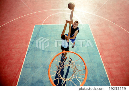 High angle view of basketball player dunking High angle view of basketball player dunking 39253259
