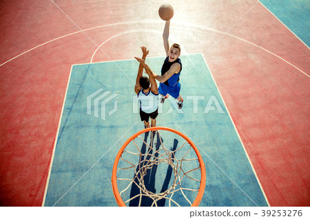 High angle view of basketball player dunking High angle view of basketball player dunking 39253276