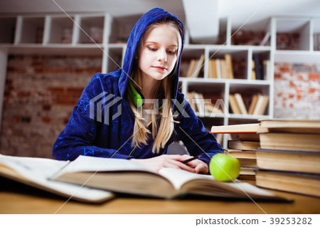 Teenage girl in a library Teenage girl in a library 39253282