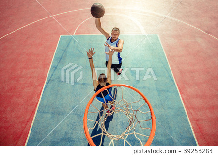 High angle view of basketball player dunking High angle view of basketball player dunking 39253283