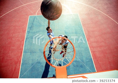 High angle view of basketball player dunking High angle view of basketball player dunking 39253374