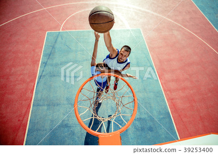 High angle view of basketball player dunking 39253400