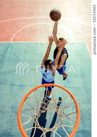 High angle view of basketball player dunking High angle view of basketball player dunking 39253405