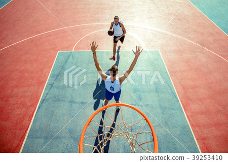 High angle view of basketball player dunking High angle view of basketball player dunking 39253410