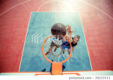 High angle view of basketball player dunking High angle view of basketball player dunking 39253513