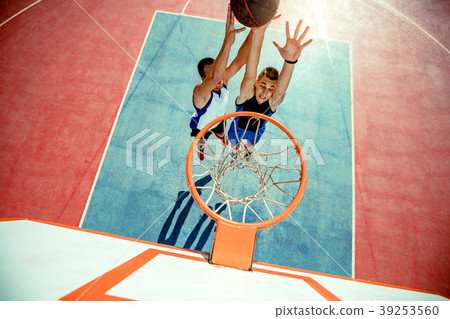 High angle view of basketball player dunking High angle view of basketball player dunking 39253560