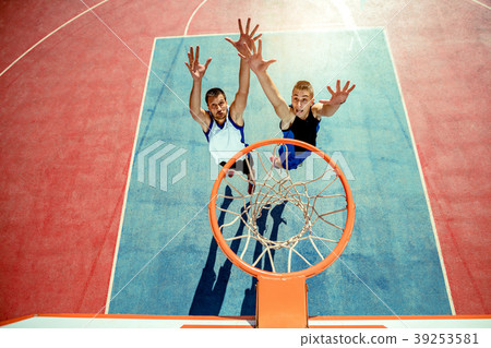 High angle view of basketball player dunking High angle view of basketball player dunking 39253581