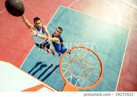 High angle view of basketball player dunking High angle view of basketball player dunking 39253822