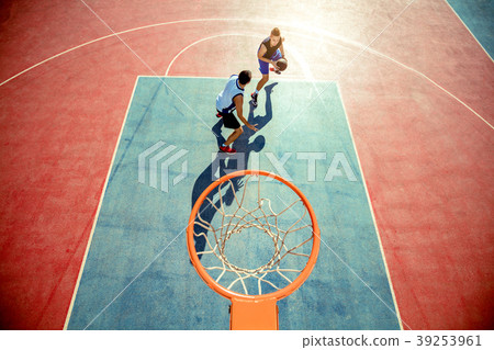 High angle view of basketball player dunking High angle view of basketball player dunking 39253961