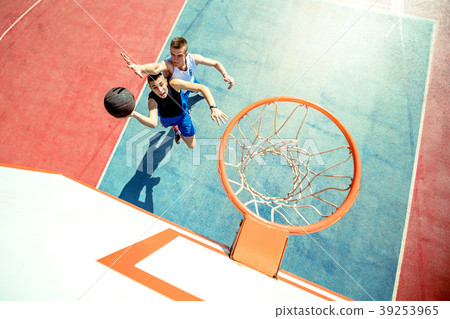 High angle view of basketball player dunking High angle view of basketball player dunking 39253965