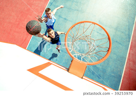 High angle view of basketball player dunking High angle view of basketball player dunking 39253970