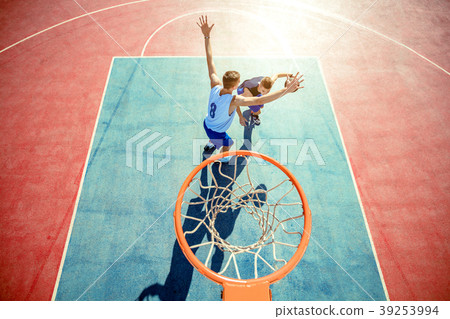 High angle view of basketball player dunking High angle view of basketball player dunking 39253994