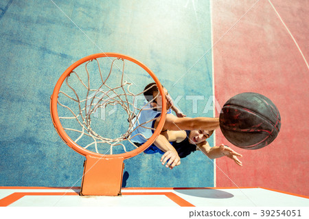 High angle view of basketball player dunking High angle view of basketball player dunking 39254051